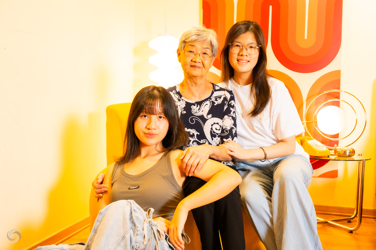 family photo shooting - Three women sitting together, smiling.